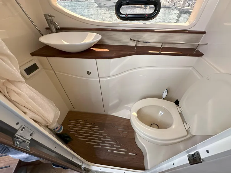 Slide: The Image of Luxurious bathroom in 2015 Sea Ray 350 Sundancer yacht with modern fixtures and wood accents. - 19