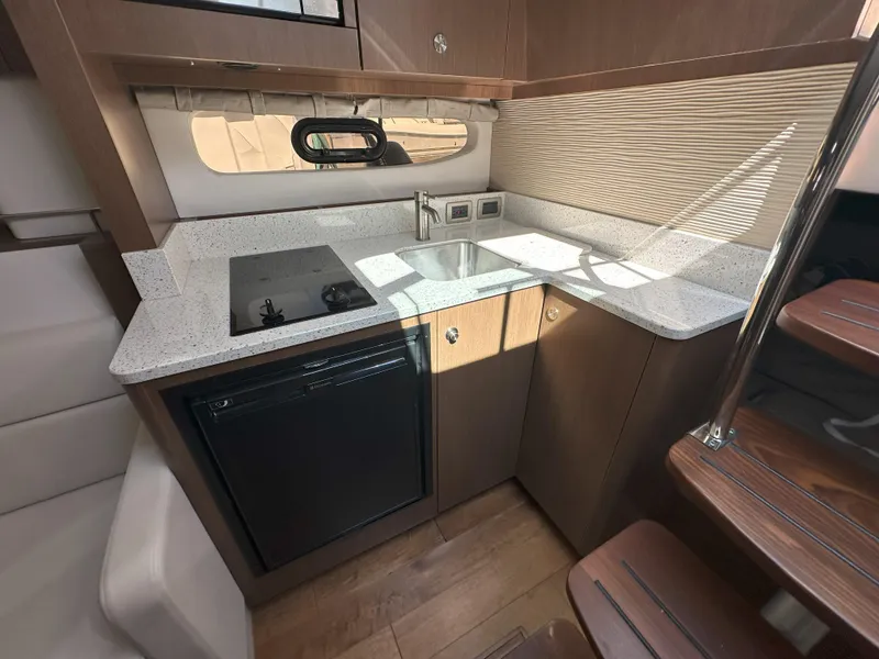 Slide: The Image of Modern kitchen area in 2015 Sea Ray 350 Sundancer yacht with sleek countertops and appliances. - 22