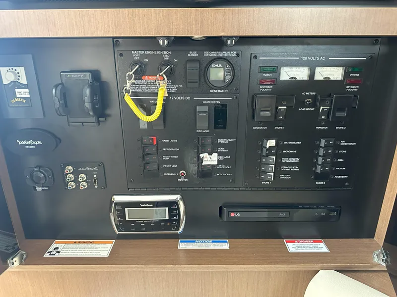 Slide: The Image of Control panel of a 2015 Sea Ray 350 Sundancer boat with various switches and meters. - 29
