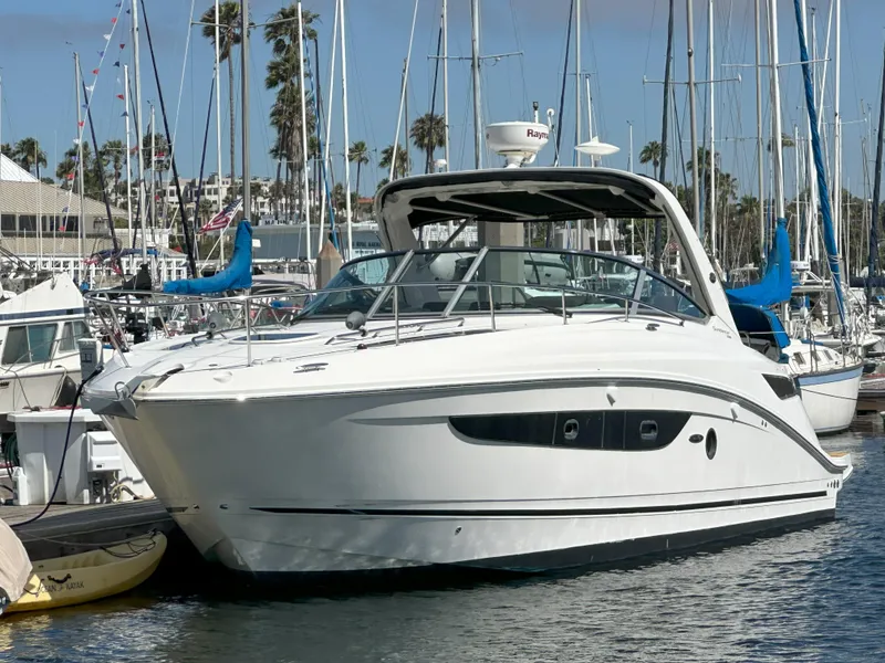 Slide: The Image of 2015 Sea Ray 350 Sundancer yacht docked in marina, surrounded by sailboats. - 3