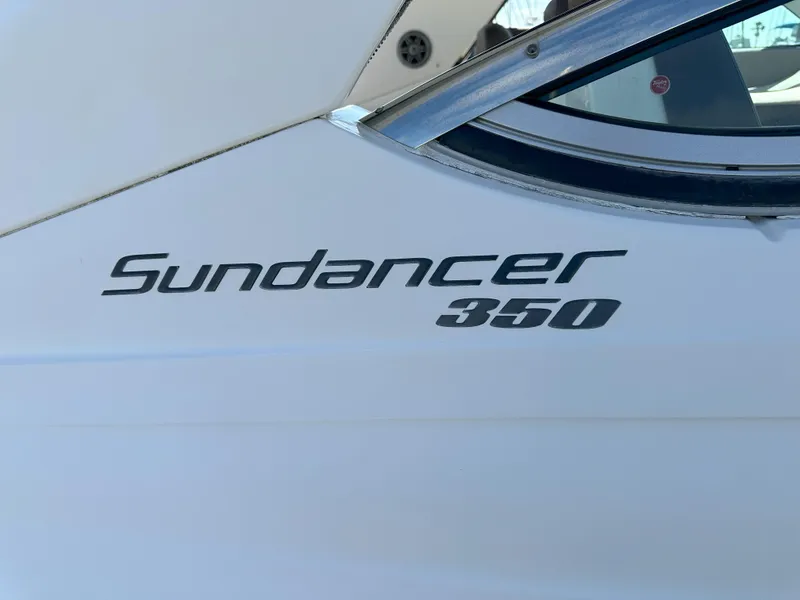 Slide: The Image of 2015 Sea Ray 350 Sundancer boat logo on white hull. - 5
