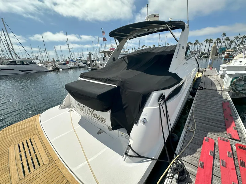 Slide: The Image of 2015 Sea Ray 350 Sundancer docked at marina, covered with black tarp. - 6