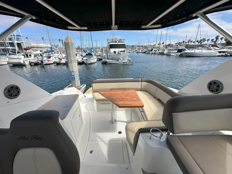 Slide: The Image of 2015 Sea Ray 350 Sundancer yacht interior with seating and table, docked at marina. - 8