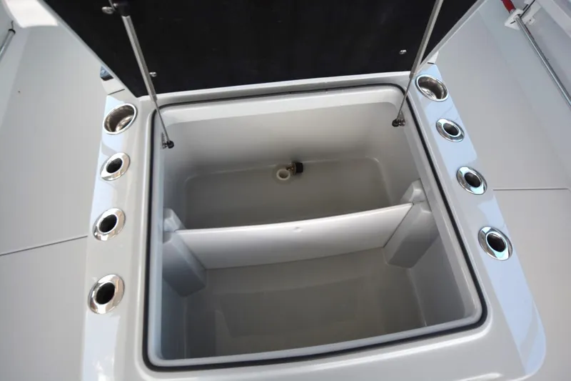 Slide: The Image of Open storage compartment on 2024 Costa Custom Boats 264HC, featuring multiple cup holders. - 10
