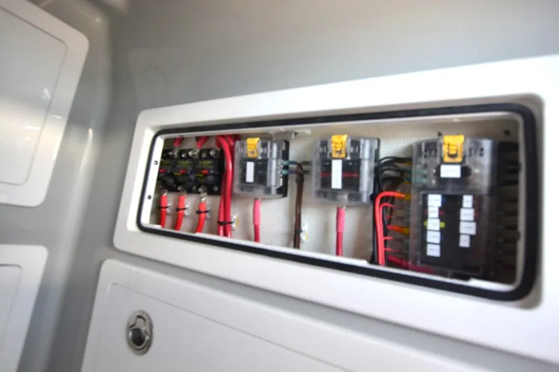 Slide: The Image of Electrical panel of 2024 Costa Custom Boats 264HC with wiring and circuit breakers. - 13