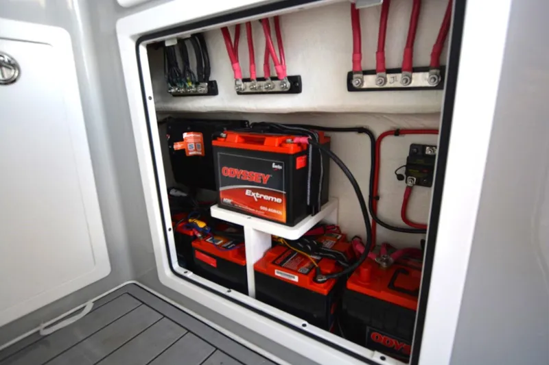 Slide: The Image of Electrical compartment of 2024 Costa Custom Boats 264HC with Odyssey batteries and wiring. - 14