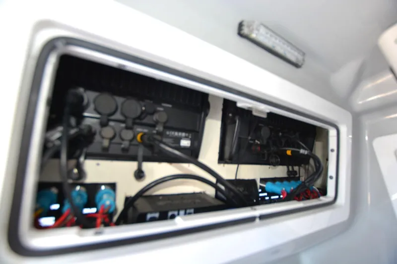 Slide: The Image of Electrical compartment of 2024 Costa Custom Boats 264HC, showcasing wiring and components. - 17