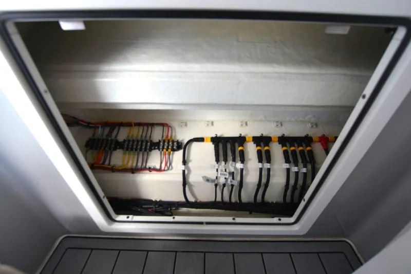 Slide: The Image of Electrical wiring compartment of 2024 Costa Custom Boats 264HC, showcasing organized cables and connections. - 18
