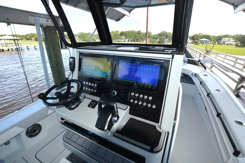 Slide: The Image of 2024 Costa Custom Boats 264HC helm with advanced navigation displays and controls. - 19