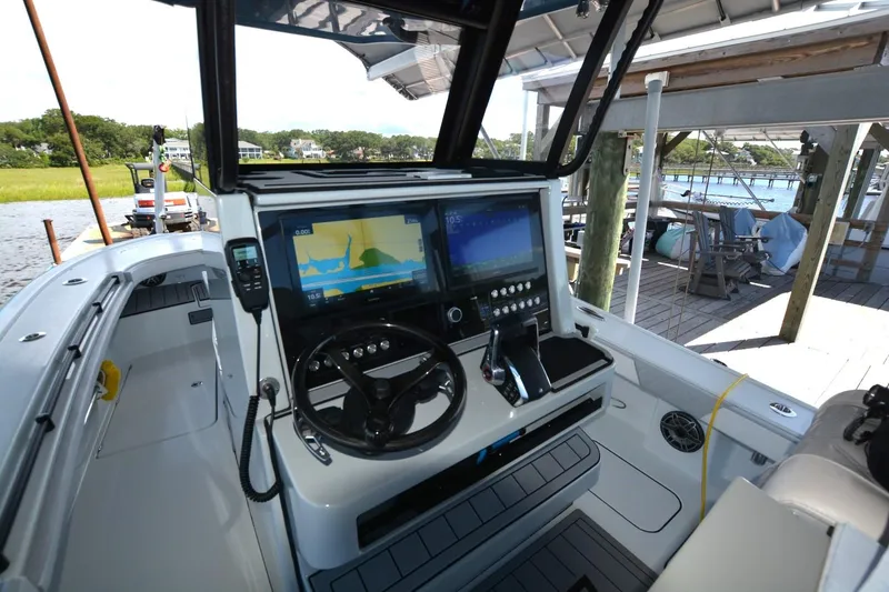 Slide: The Image of 2024 Costa Custom Boats 264HC helm with advanced navigation displays and controls. - 20