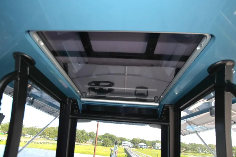 Slide: The Image of 2024 Costa Custom Boats 264HC interior view with sunroof and steering wheel. - 22