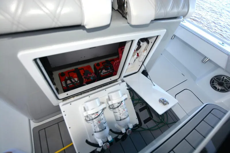 Slide: The Image of 2024 Costa Custom Boats 264HC interior showing battery compartment and fire extinguishers. - 27
