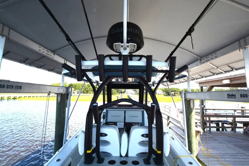 Slide: The Image of 2024 Costa Custom Boats 264HC under canopy, featuring Garmin electronics and sleek design. - 28