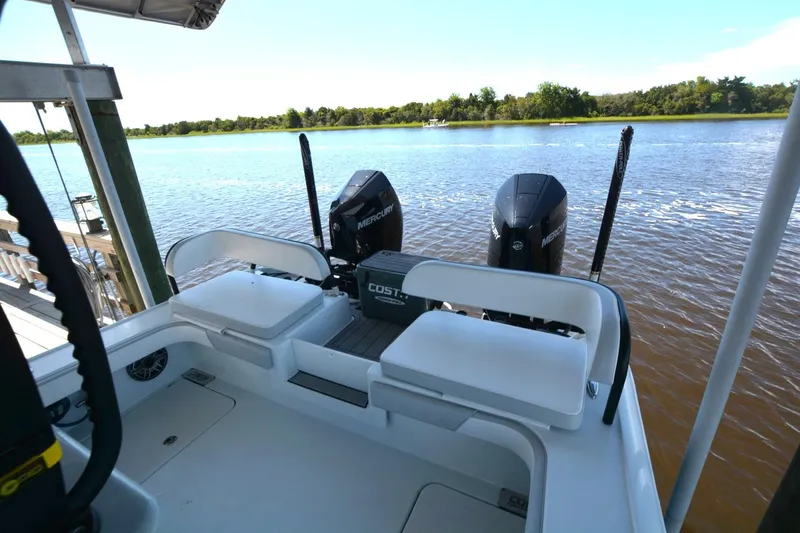 Slide: The Image of 2024 Costa Custom Boats 264HC with dual Mercury engines on a serene river. - 32