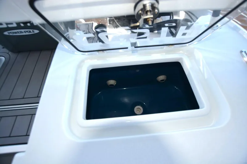 Slide: The Image of Livewell compartment on 2024 Costa Custom Boats 264HC, featuring a sleek design and durable construction. - 34