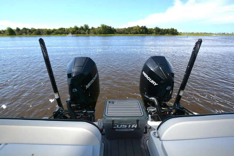 Slide: The Image of 2024 Costa Custom Boats 264HC with dual Mercury engines on a serene lake. - 35