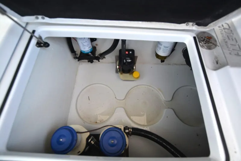 Slide: The Image of 2024 Costa Custom Boats 264HC storage compartment with filters and hoses. - 36