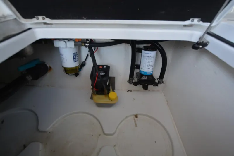 Slide: The Image of 2024 Costa Custom Boats 264HC interior compartment with Shurflo pump and wiring. - 37