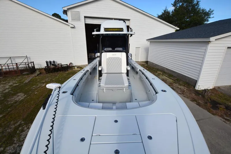 Slide: The Image of 2024 Costa Custom Boats 264HC in a driveway, showcasing sleek design and spacious deck. - 6