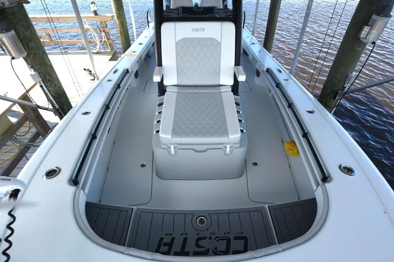 Slide: The Image of 2024 Costa Custom Boats 264HC interior with cushioned seating and sleek design. - 8