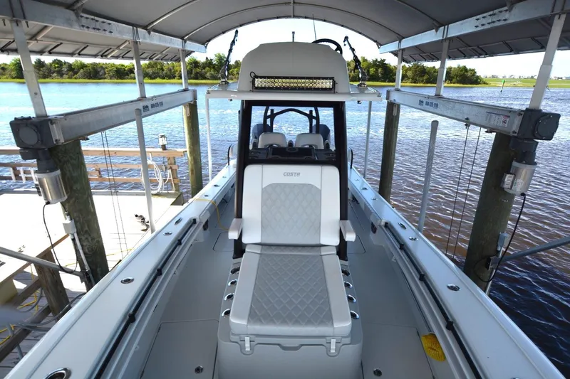 Slide: The Image of 2024 Costa Custom Boats 264HC docked, showcasing sleek design and spacious seating. - 9