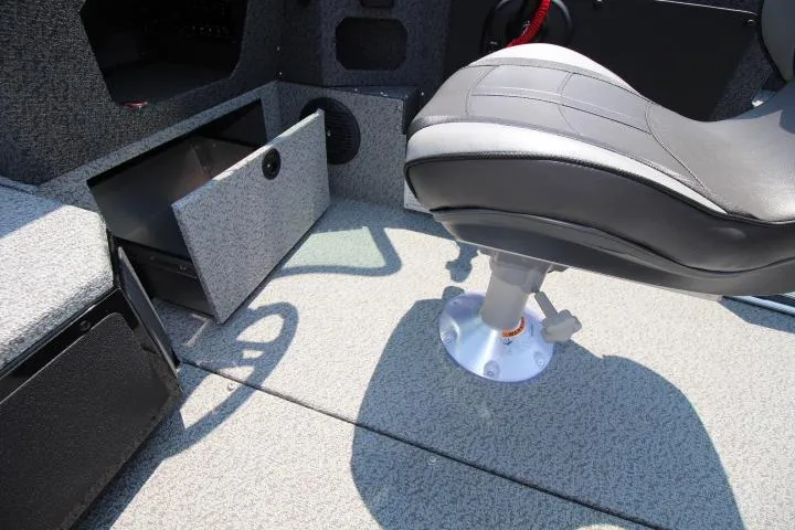 Slide: The Image of 2025 Lund 1875 Impact XS Sport boat interior with storage compartment and swivel seat. - 10