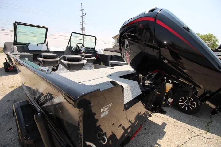 Slide: The Image of 2025 Lund 1875 Impact XS Sport boat with powerful outboard motor, sleek design. - 2