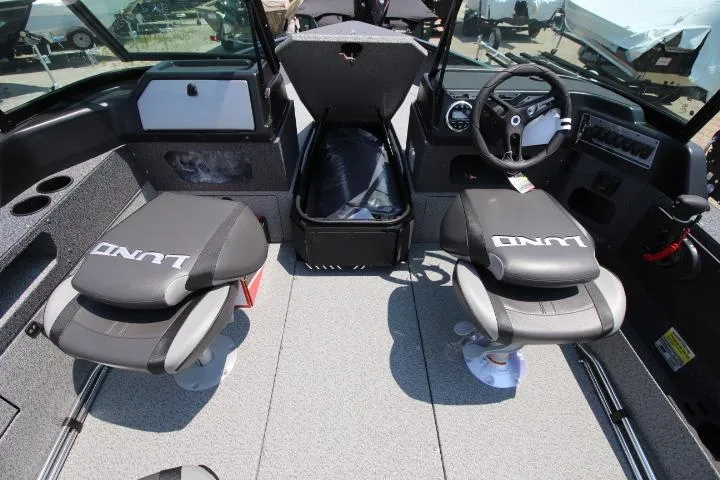 Slide: The Image of 2025 Lund 1875 Impact XS Sport boat interior with seating and steering console. - 3