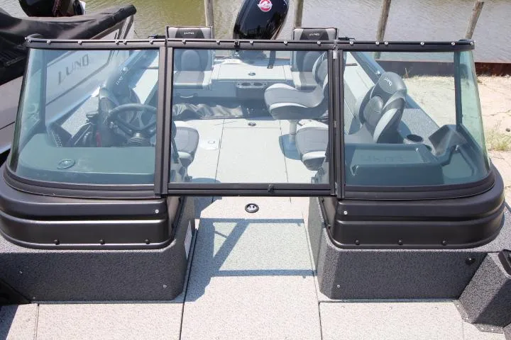 Slide: The Image of 2025 Lund 1875 Impact XS Sport boat interior with seating and windshield. - 4
