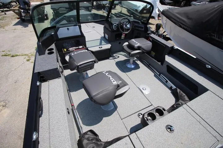 Slide: The Image of 2025 Lund 1875 Impact XS Sport boat interior with seating and steering console. - 7