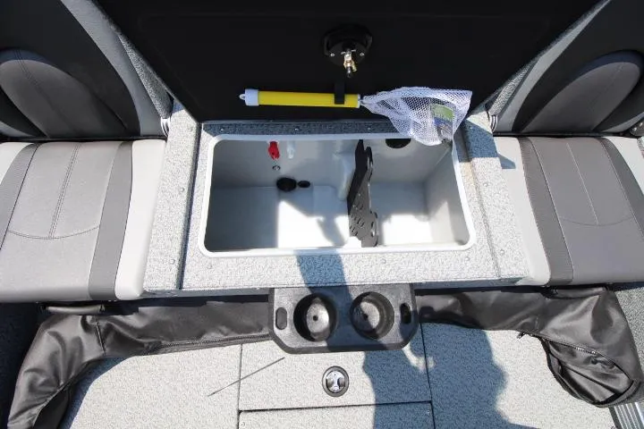 Slide: The Image of 2025 Lund 1875 Impact XS Sport boat interior with storage compartment and cup holders. - 9