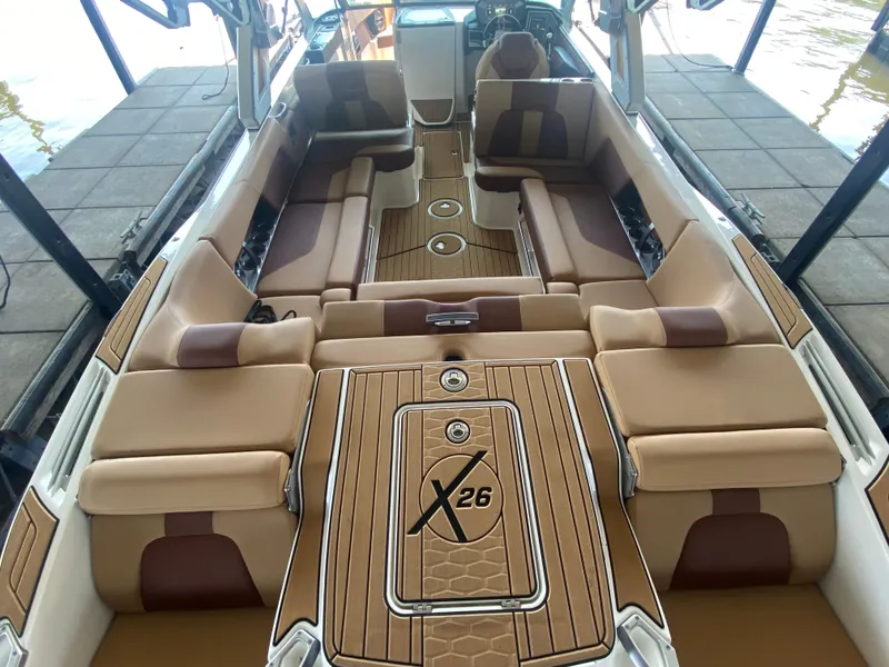Slide: The Image of 2022 MasterCraft X26 boat interior with luxurious tan seating and sleek design. - 19