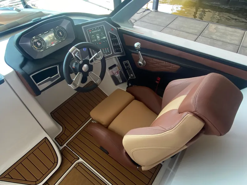 Slide: The Image of 2022 MasterCraft X26 boat cockpit with modern controls and luxurious seating. - 28