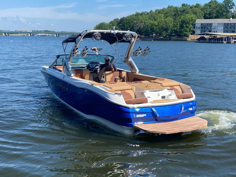 Slide: The Image of 2022 MasterCraft X26 boat on a lake, featuring sleek design and luxurious seating. - 3