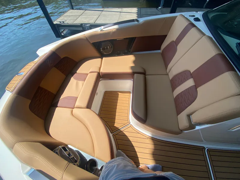Slide: The Image of Luxurious seating on 2022 MasterCraft X26 boat, featuring tan and brown upholstery. - 38