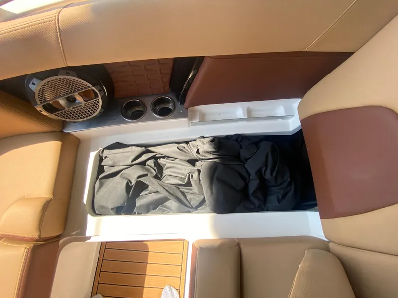 Slide: The Image of 2022 MasterCraft X26 boat interior with storage compartment and speaker system. - 40