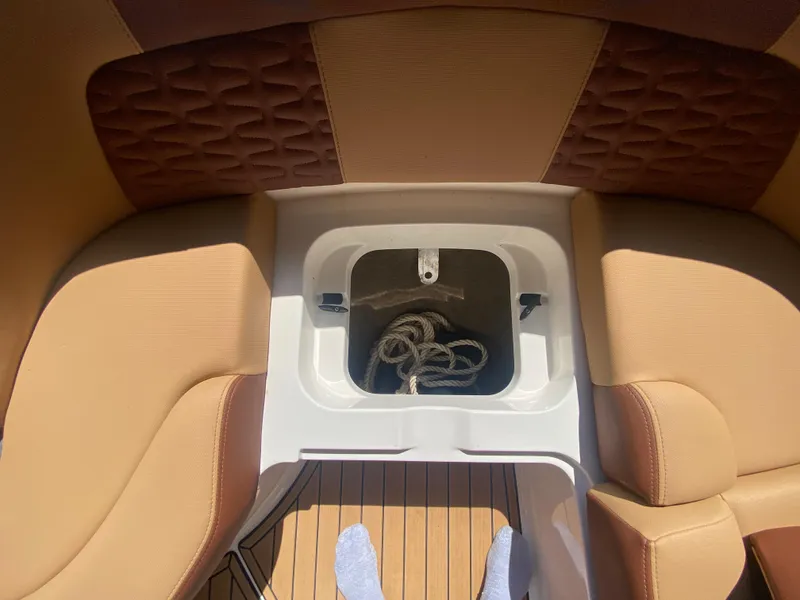 Slide: The Image of 2022 MasterCraft X26 boat interior with storage compartment and rope. - 41