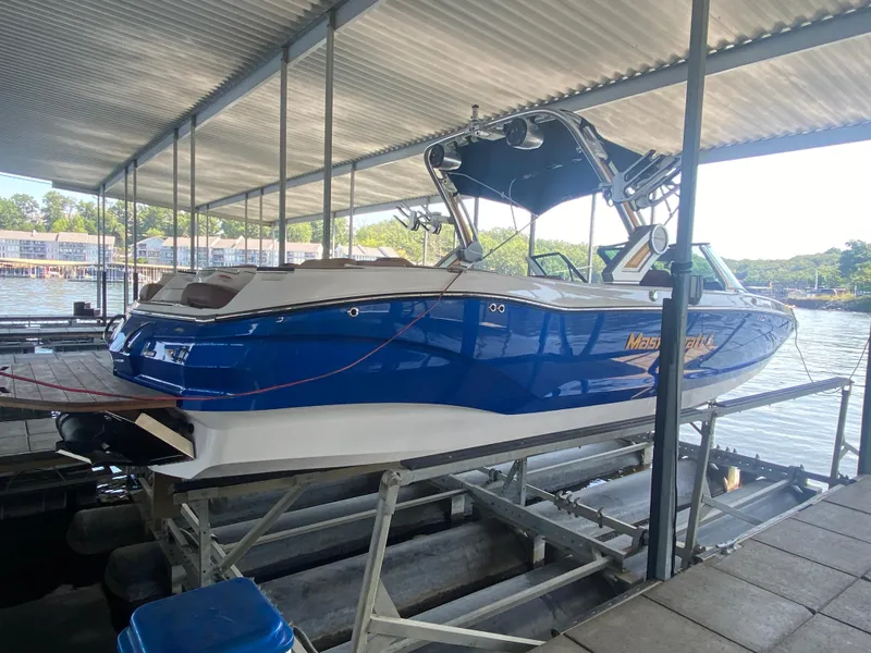 Slide: The Image of 2022 MasterCraft X26 boat docked under a covered marina. - 46
