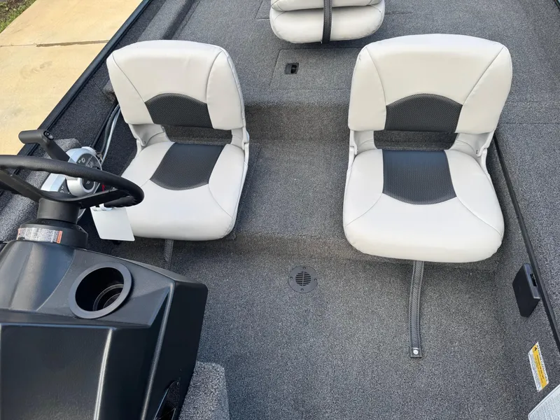 Slide: The Image of 2025 Crestliner 1700 Storm boat interior with two gray seats and steering console. - 3