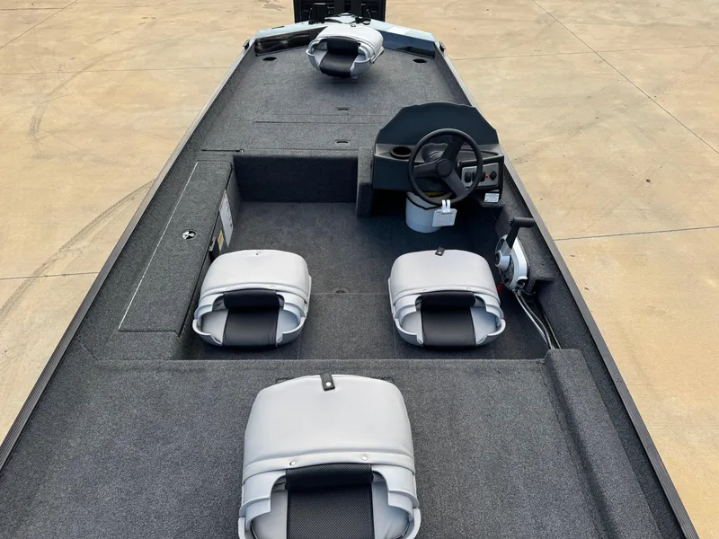 Slide: The Image of 2025 Crestliner 1700 Storm boat interior with gray seating and steering console. - 4