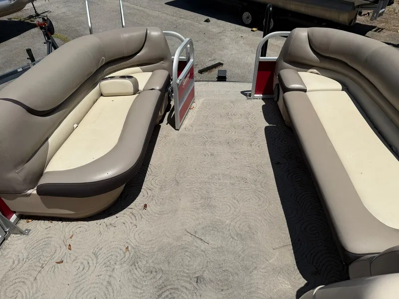 Slide: The Image of 2015 Sun Tracker Party Barge 20 DLX interior with beige seating and open deck. - 4