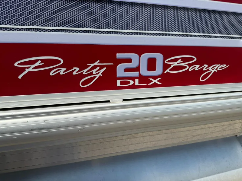 Slide: The Image of 2015 Sun Tracker Party Barge 20 DLX logo on red background. - 8