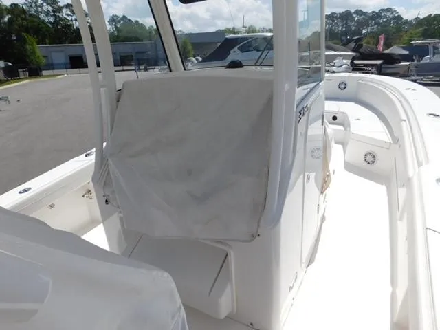 Slide: The Image of 2024 Regulator 30XO boat interior with covered console, docked outdoors. - 10