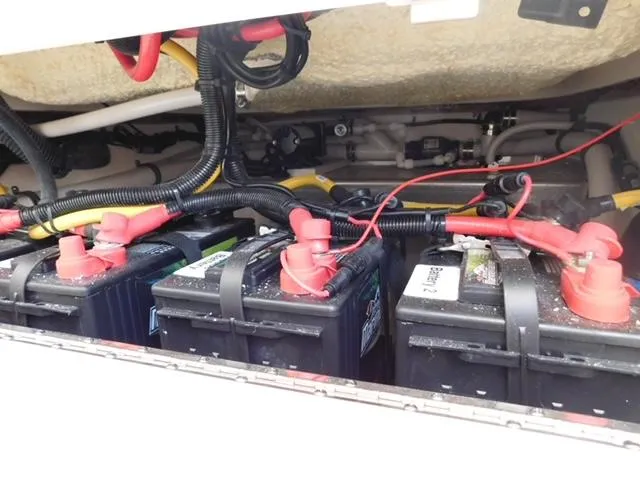 Slide: The Image of 2024 Regulator 30XO boat battery compartment with multiple batteries and wiring. - 12