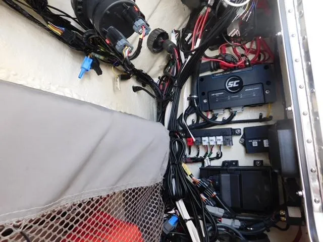 Slide: The Image of 2024 Regulator 30XO boat wiring and electrical components in storage compartment. - 13