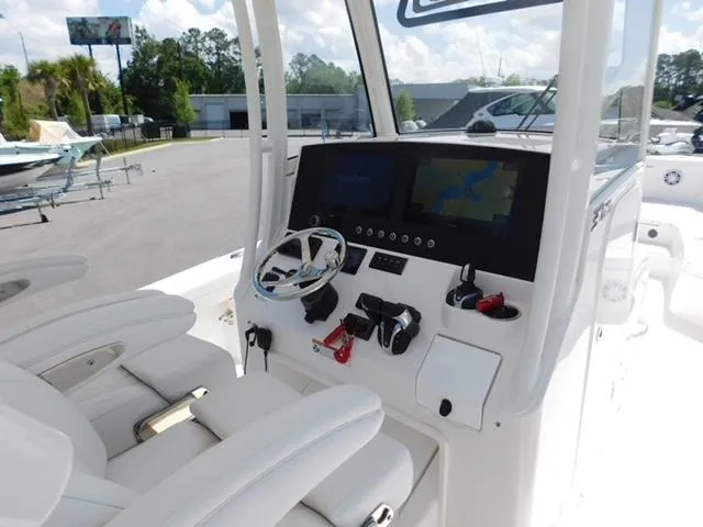Slide: The Image of 2024 Regulator 30XO boat console with dual screens and steering wheel. - 15