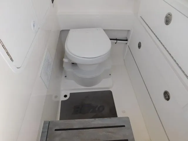 Slide: The Image of 2024 Regulator 30XO boat interior with compact marine toilet. - 17