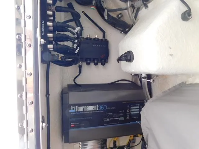 Slide: The Image of Electrical components inside a 2024 Regulator 30XO boat, featuring ProTournament 360 charger. - 19