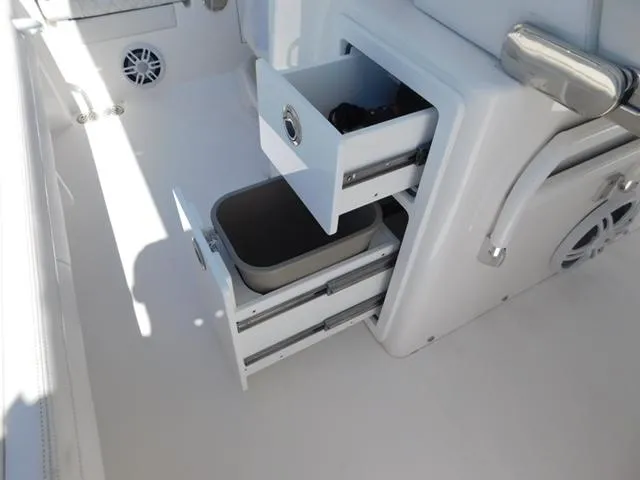 Slide: The Image of 2024 Regulator 30XO boat interior with open storage compartments and sleek design. - 21