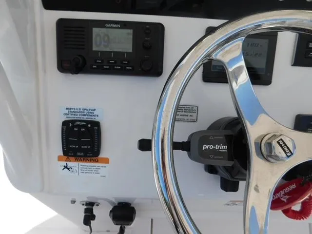 Slide: The Image of 2024 Regulator 30XO boat dashboard with Garmin display and steering wheel. - 24